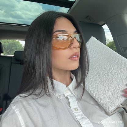 Woman sitting in a car holding the Kainos Bare White Boucle Bible cover on a CSB She Reads Truth Bible