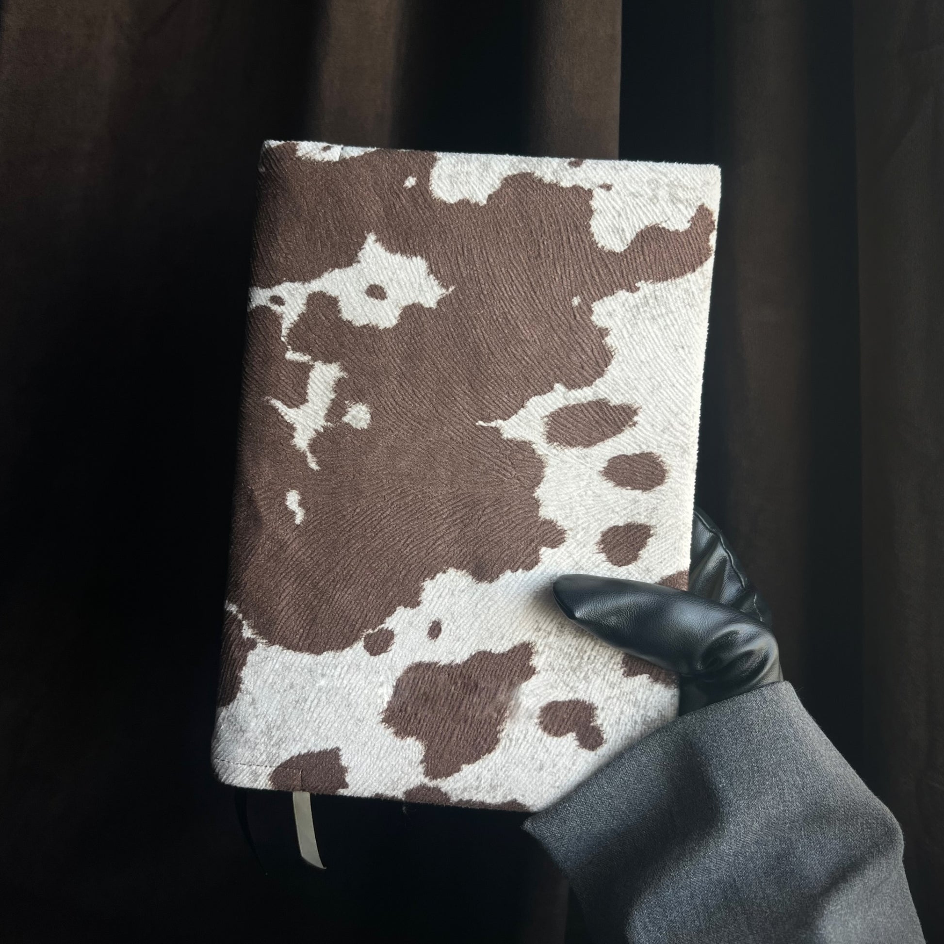 Kainos Studios Bare Brown Cow Print Bible Cover in Hand