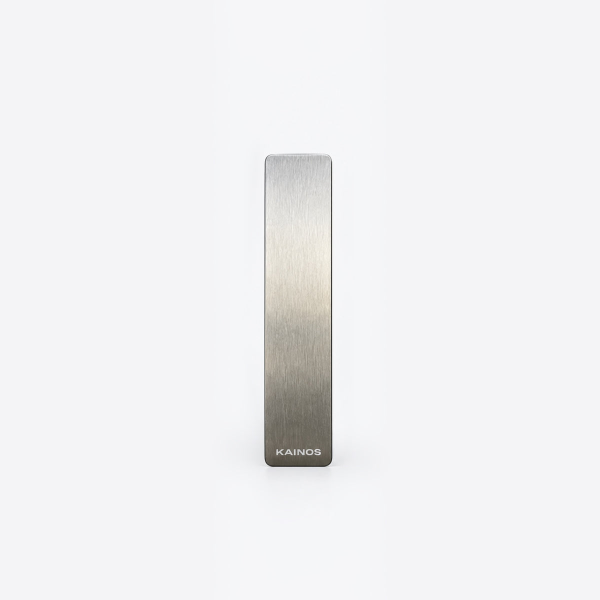 A slim, rectangular brushed metal bar with a silver-to-gray gradient finish and the brand name 'KAINOS' printed at the bottom, centered on a plain white background.
