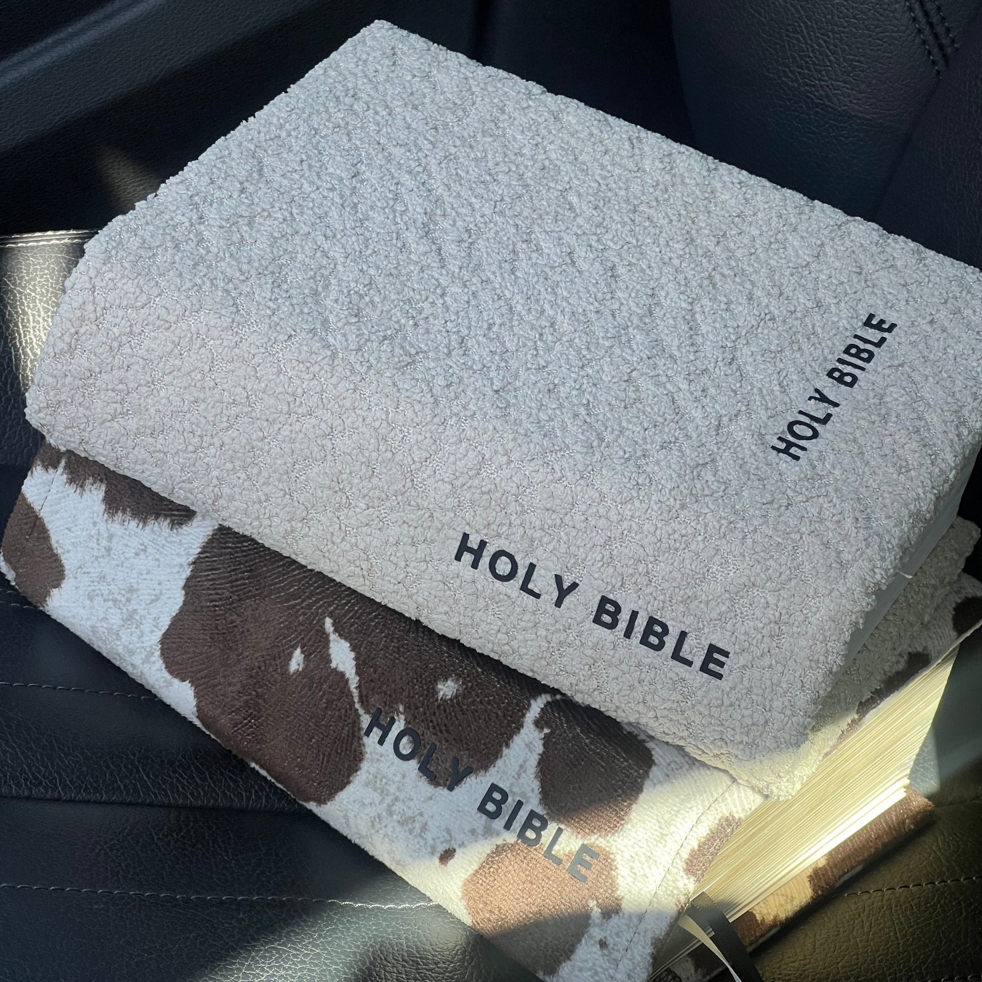 Holy Bible in a car with a cow print cover