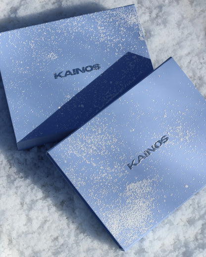 Two blue boxes with 'KAINOS' branding on a textured surface