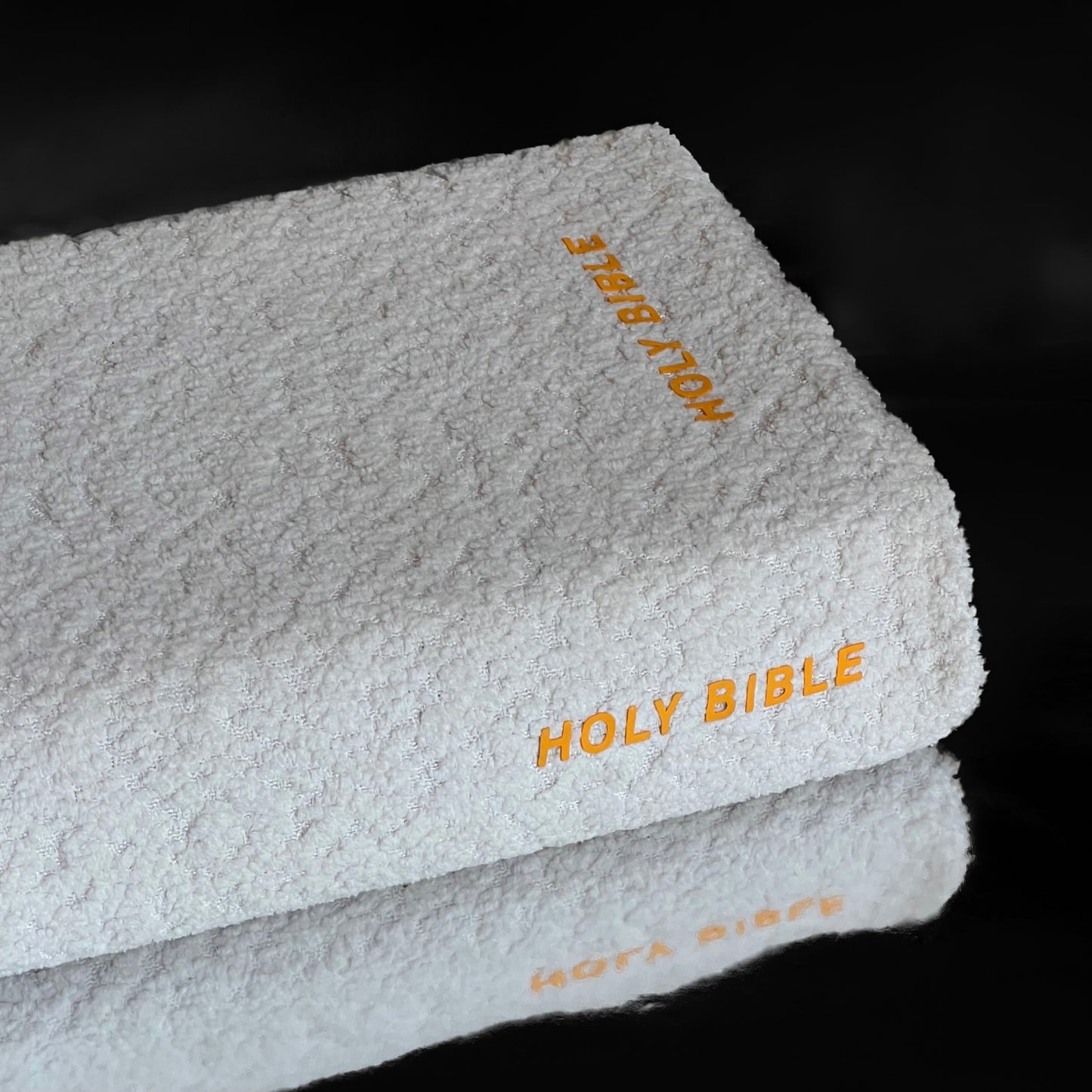 White boucle bible cover with lemon yellow text